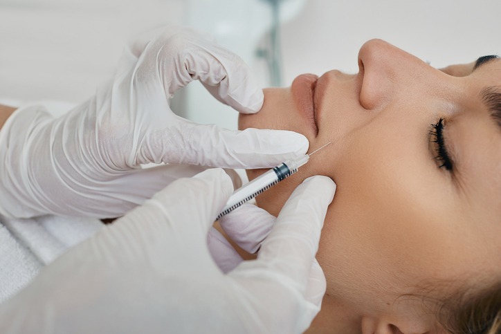 Female face with mimic wrinkles near mouth, beautician doing injection into nasolabial folds. Botulinum toxin injection for remove wrinkle Cosmetic Fillers in York Pa