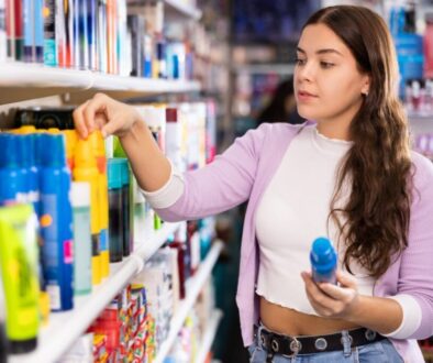 Woman trying to select the best sunscreen.