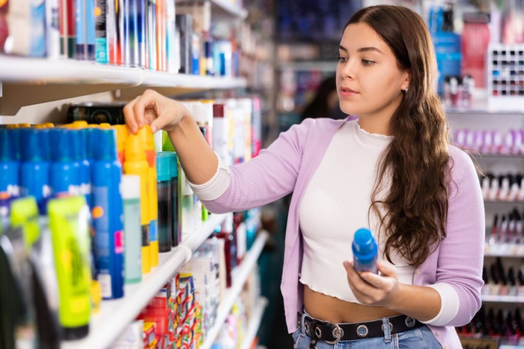Woman trying to select the best sunscreen.